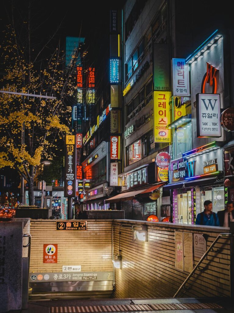 Seoul subway station entrance with English and Korean signs showing train directions.