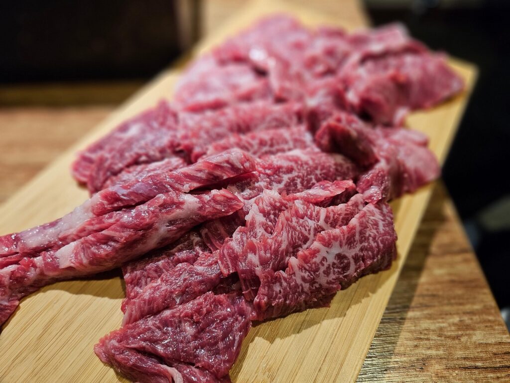 Raw slices of Hanwoo anchangsal, the tender Korean skirt steak cut known for its rich marbling and deep beef flavor.