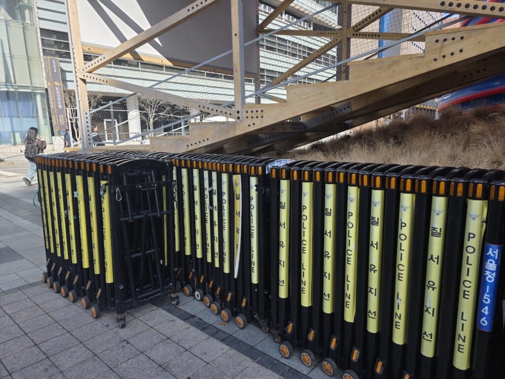 bts-gwanghwamun-comeback-2026-safety-barriers Police line and safety barriers prepared for the **BTS Gwanghwamun Comeback 2026** crowd control.
