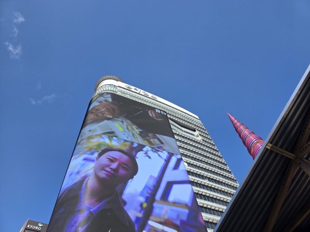 bts-gwanghwamun-locations-2026-cityscape The high-rise buildings and clear sky of Gwanghwamun for the **BTS Gwanghwamun Locations 2026**.