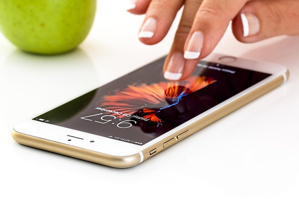 "A close-up shot of hands changing a SIM card in a smartphone, symbolizing mobile setup and connectivity for foreigners in Korea 2025."