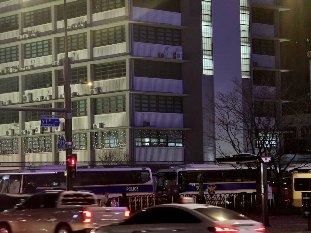 A cinematic night view of the U.S. Embassy in Seoul, illustrating the complex legal and diplomatic infrastructure required to fulfill D-8 visa Korea requirements.