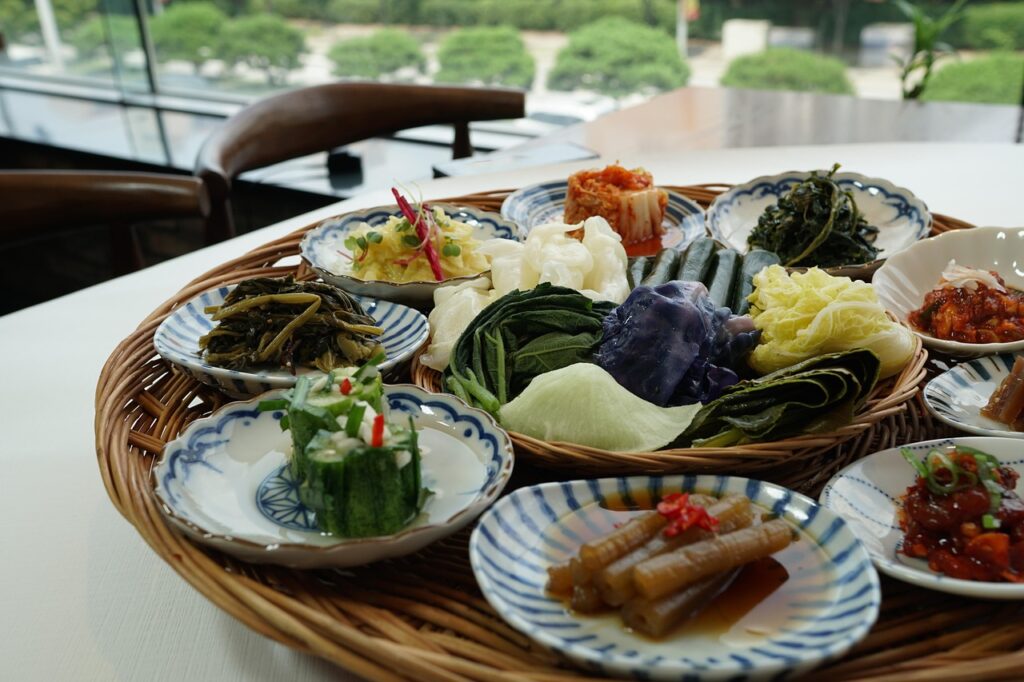 A full table of various Korean dishes and side dishes (Banchan) at a traditional restaurant, explaining why tipping in South Korea is not required even for such great service.