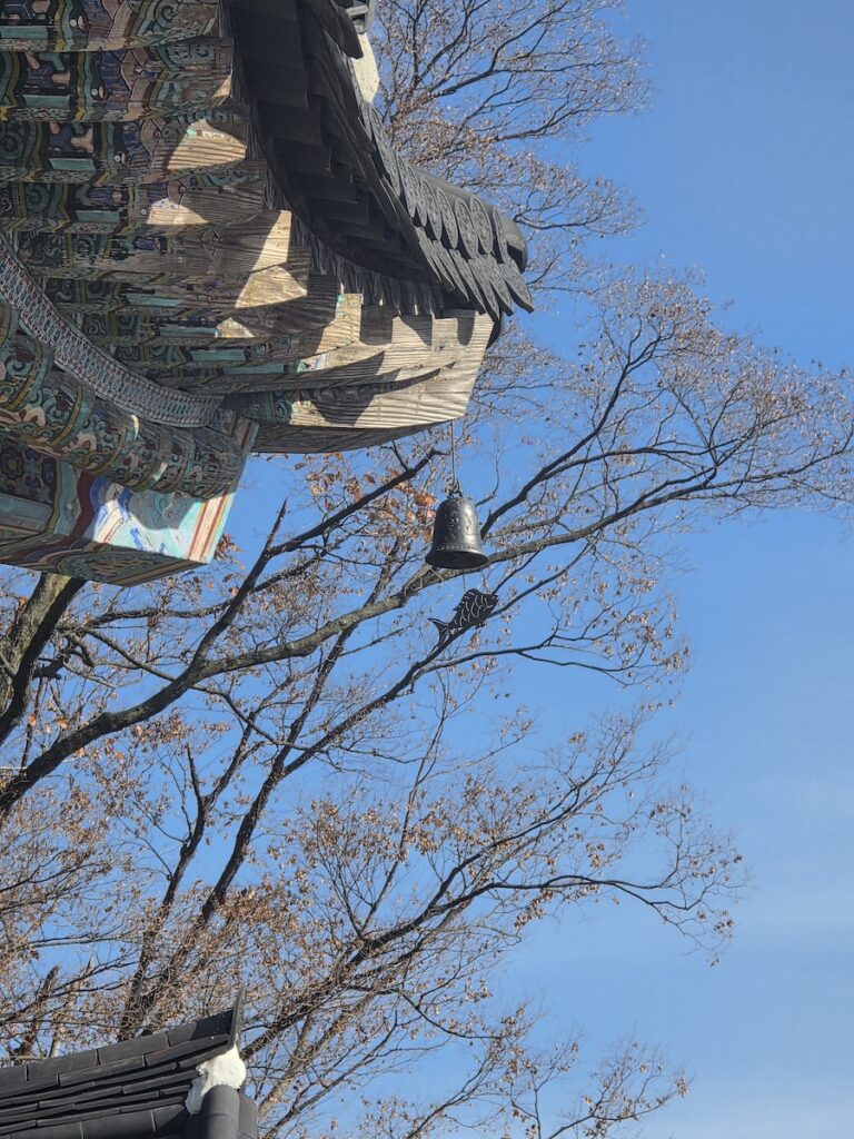 digital-detox-korea-temple-bell-sky Digital detox Korea image showing a quiet temple bell under a clear blue sky, reflecting silence and slower time at a Korean templestay