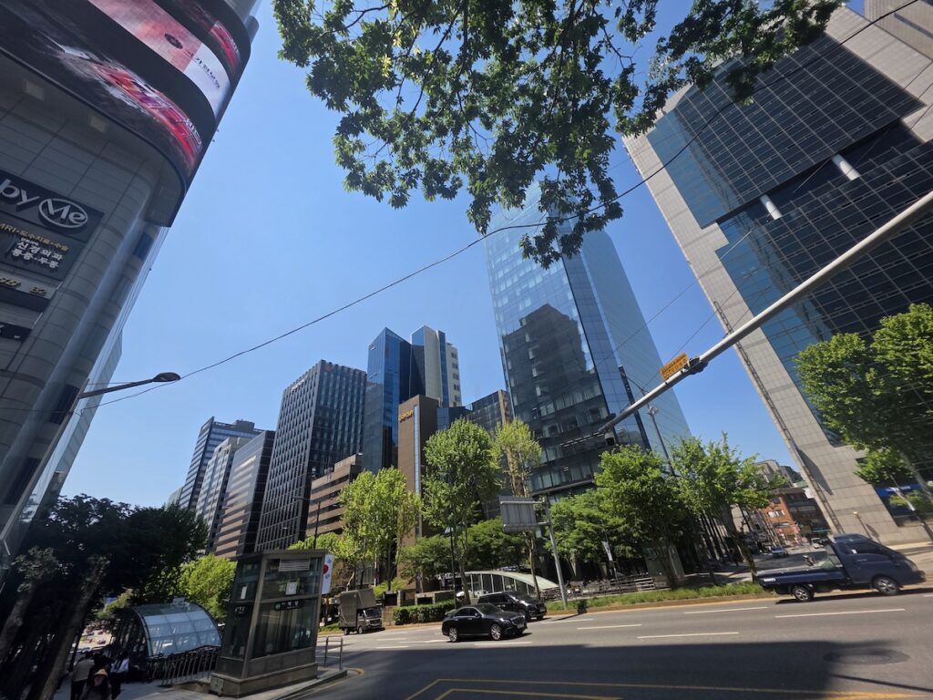 early-summer-seoul-downtown-street Early Summer in Seoul with bright blue skies, green street trees, and modern downtown office buildings during a warm afternoon in Korea