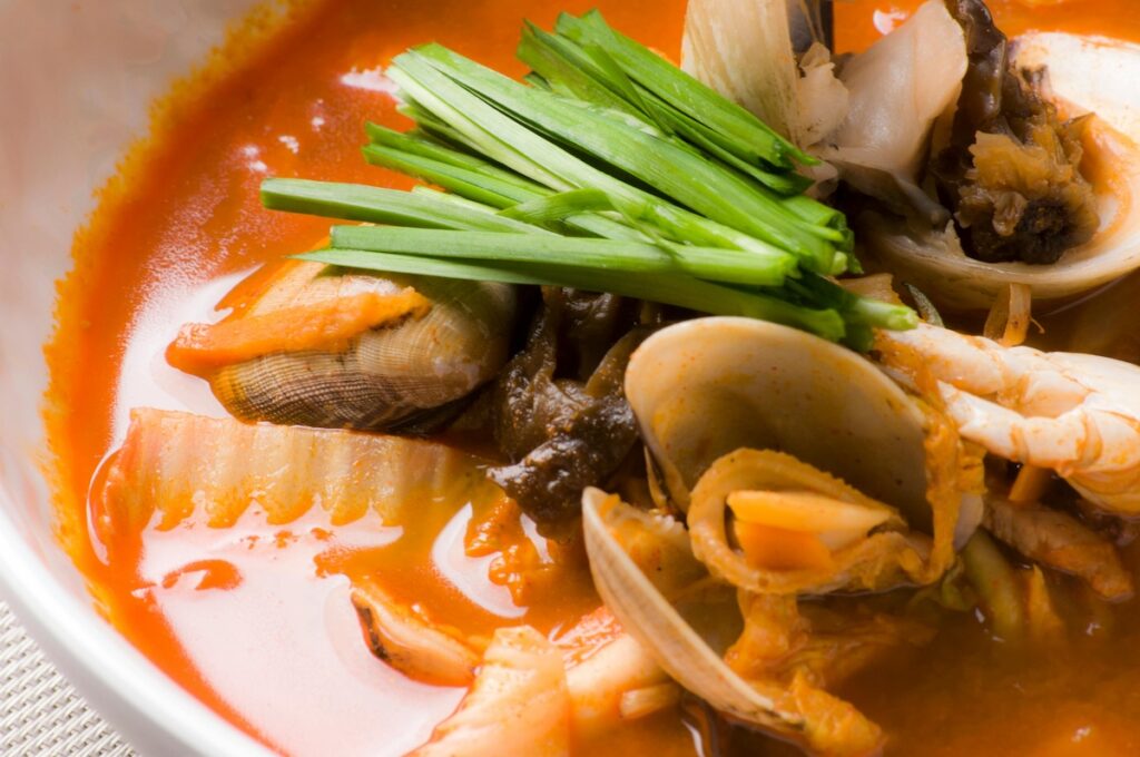 An assortment of fresh seafood ingredients such as squid, mussels, and shrimp prepared for making Korean jjambbong in 2025.