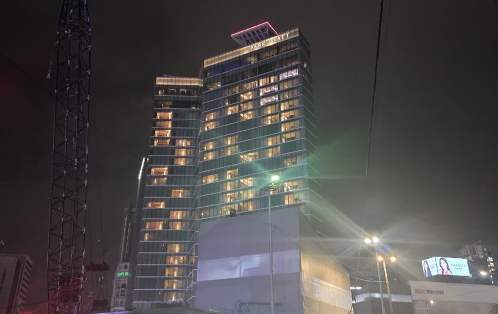 Gangnam Luxury Hotels at night, showcasing the cinematic skyline and high-end infrastructure near Teheran Road in Seoul.
