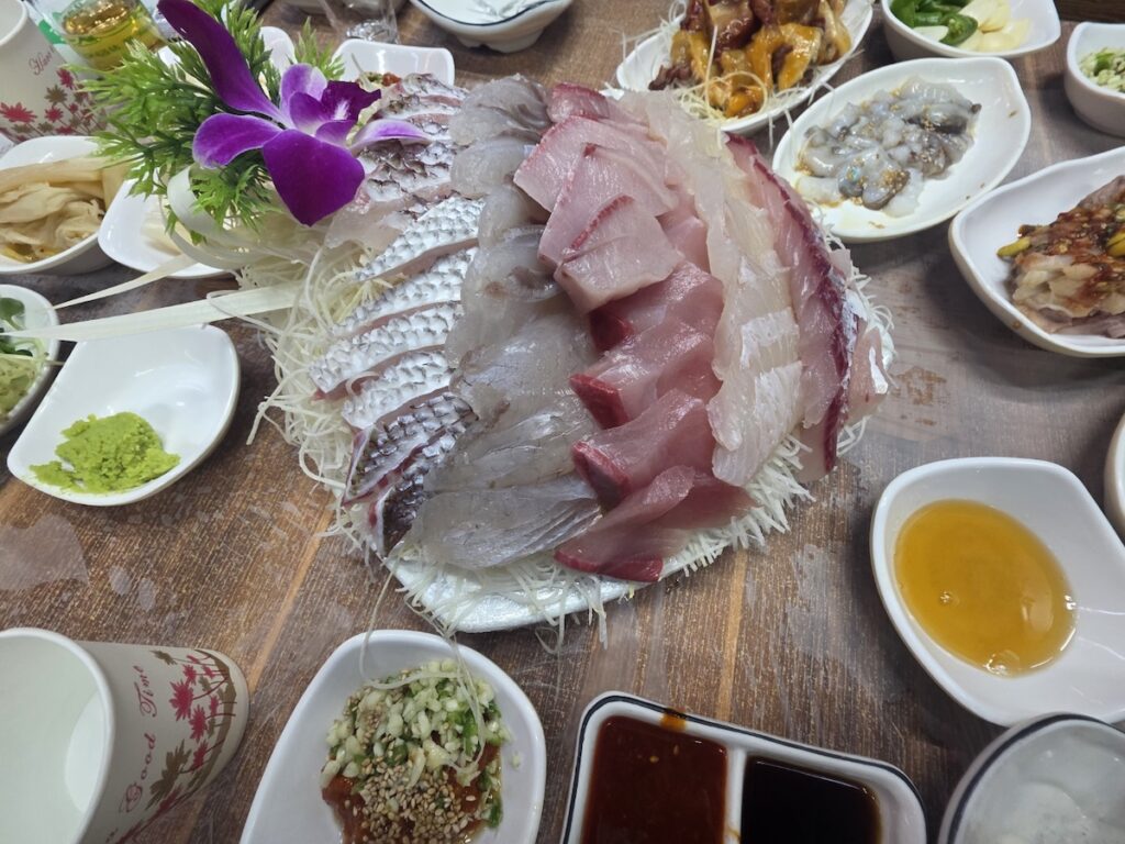 Premium fresh sashimi platter at Garak Market, featuring thick-cut seasonal fish with a bouncy texture.