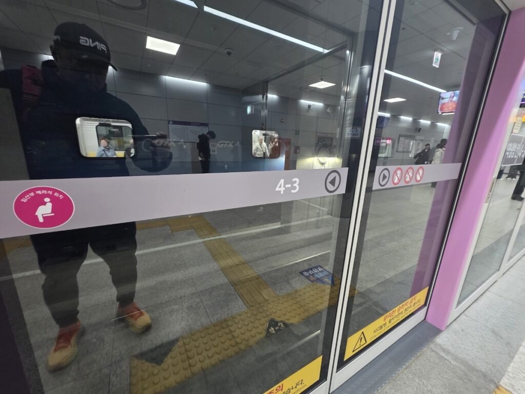how everyday life works in Korea shown through a Seoul subway platform with safety doors, priority seat signs, and public rules