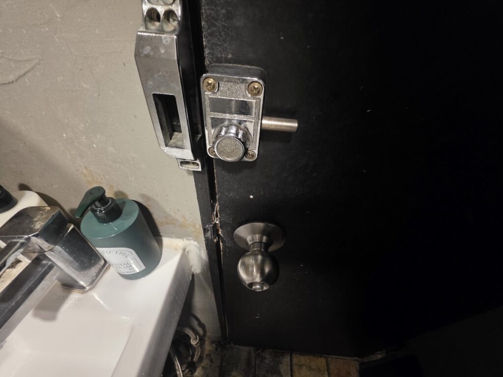 korea-toilet-etiquette-door-lock-etiquette A close-up of a unique manual door lock and a clean sink area in a Seoul cafe, highlighting attention to detail in Korea toilet etiquette.