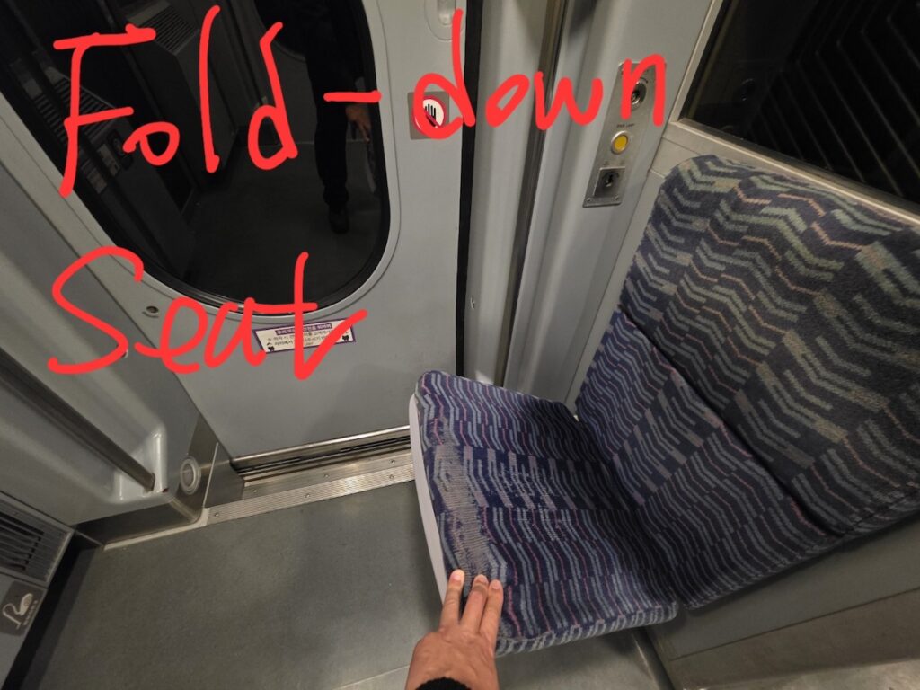 Korea Travel: KTX Standing Ticket Ritual - The jump seat sanctuary in the train vestibule.