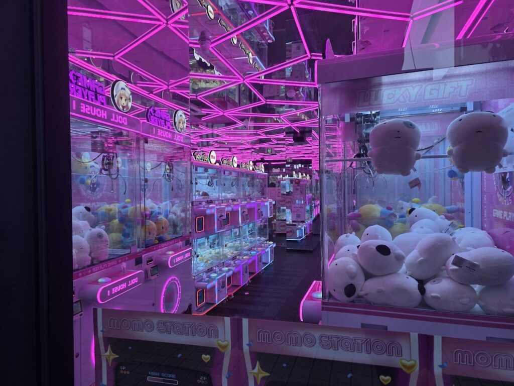 A 24-hour neon-lit claw machine arcade in Korea, a glowing temptation for traveling families.