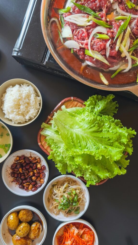 “Traditional Korean dining table with rice, soup, and side dishes”