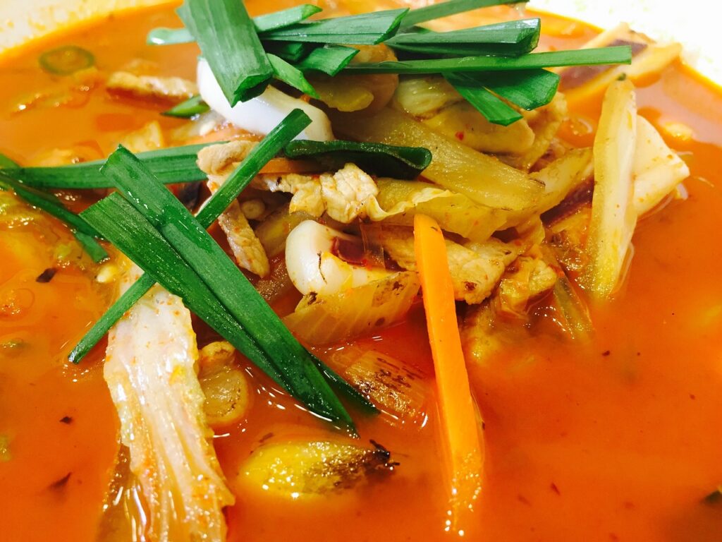 korean-jjambbong-hot-seafood-noodle-soup-2025 “A steaming bowl of Korean jjambbong filled with spicy red broth, noodles, squid, mussels, and vegetables, capturing the heat and flavor of traditional Korean comfort food.”