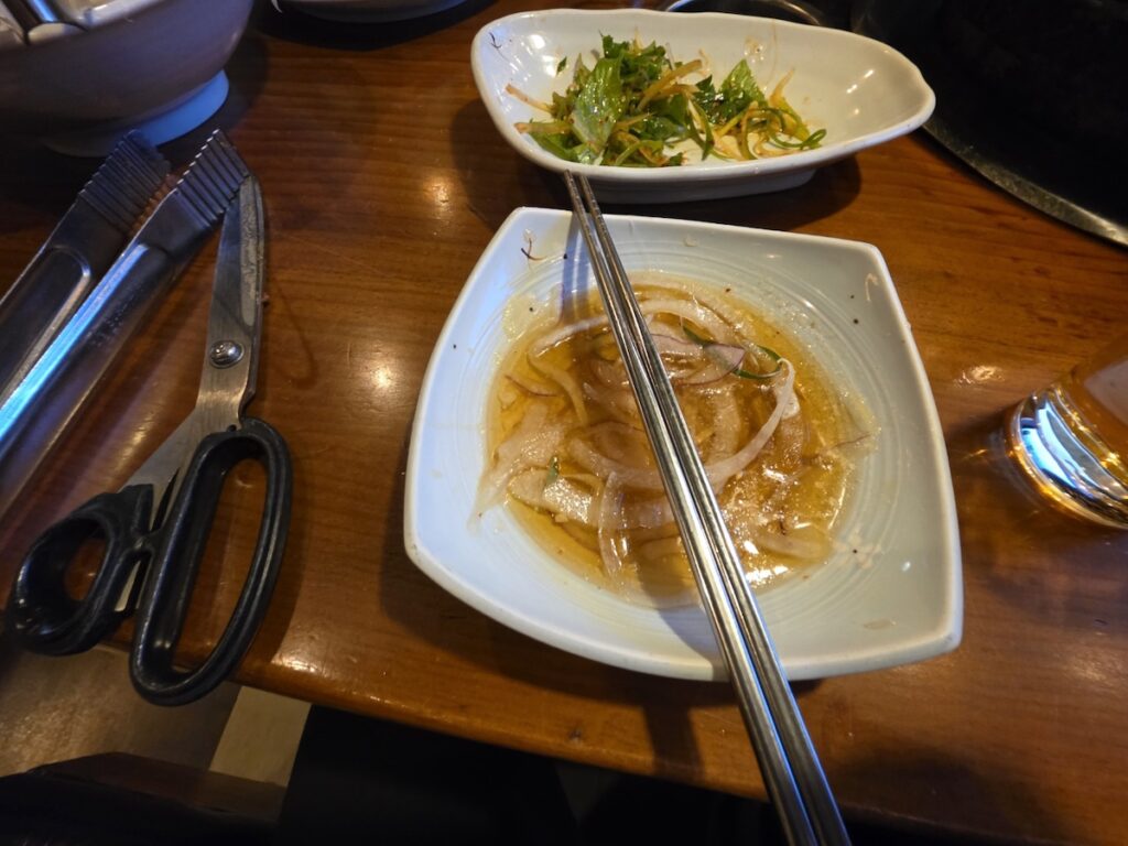 korean-marinated-pork-dipping-sauce-onions Close-up of thinly sliced onions in a special sweet and savory soy sauce, the perfect pairing for marinated pork ribs.