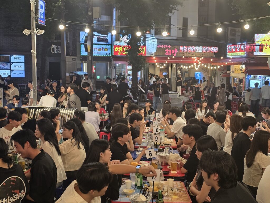 Packed night tables at a Jongno pocha street, Korean outdoor drinking culture at full volume