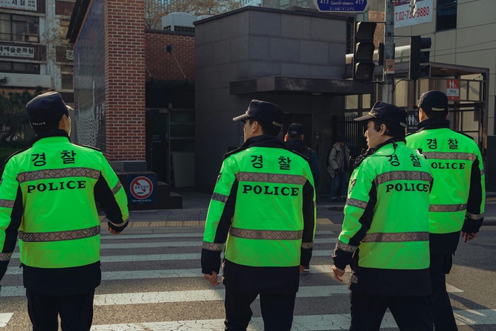 korean-police-officer-patrol “Korean police officer on patrol in Seoul street ensuring public safety”
