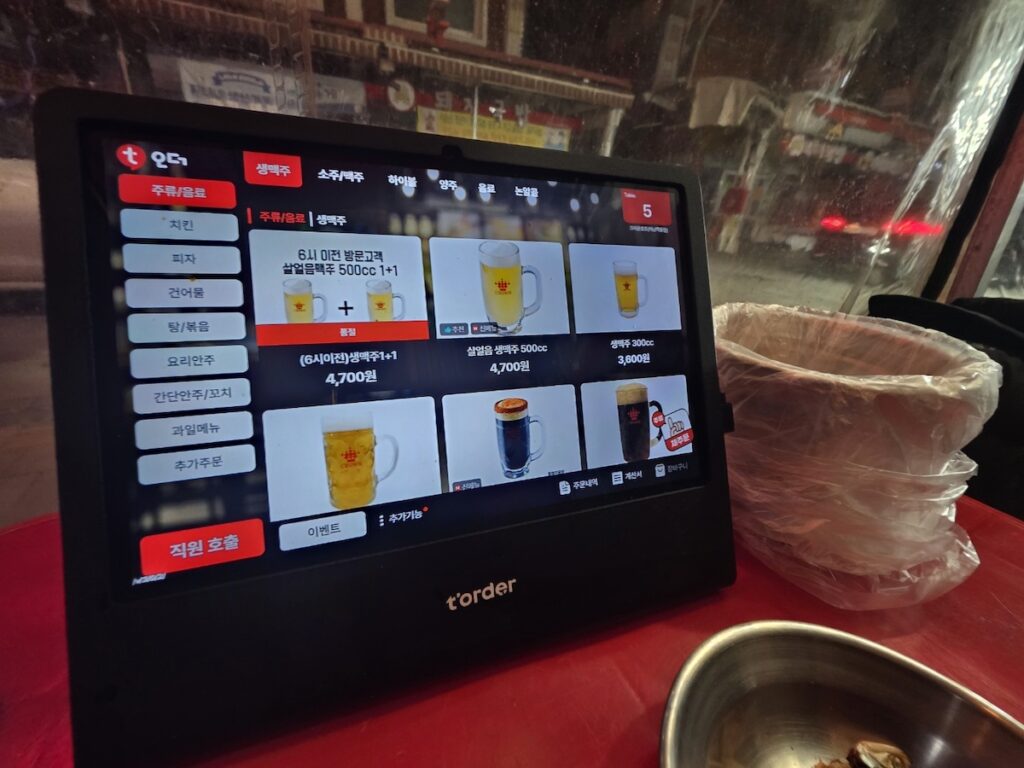 Digital T-order kiosk screen showing beer menu at a Korean bar.