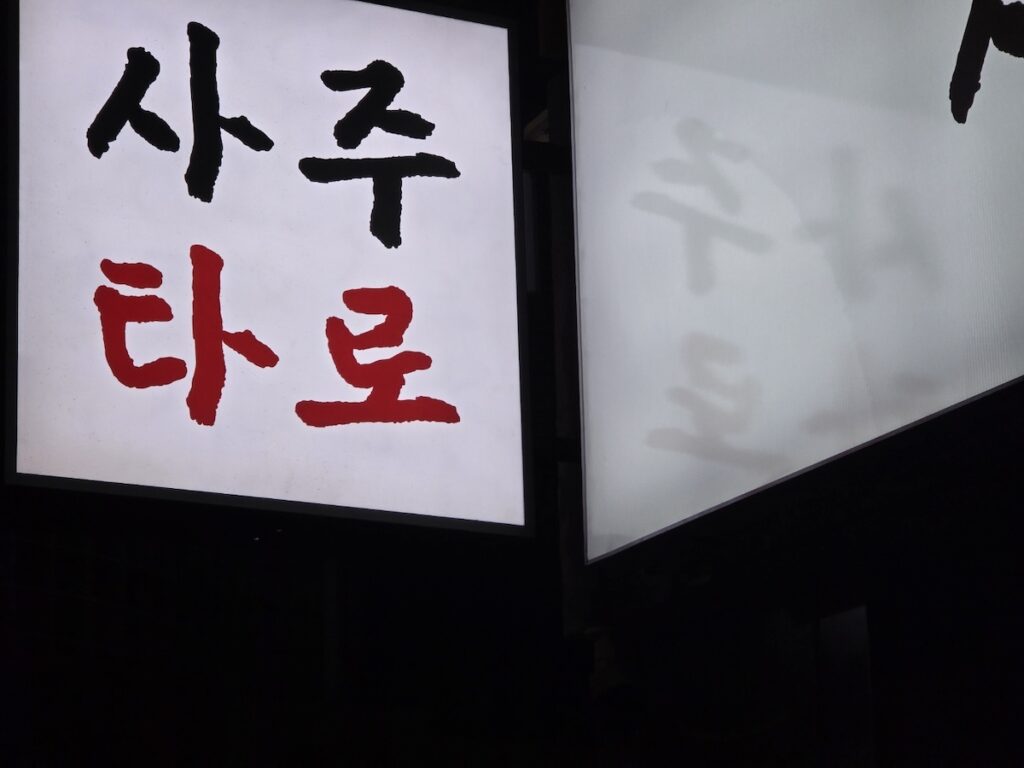 korean-saju-tarot-signboard-ritual A minimalist shot of a traditional Saju and Tarot signboard in Seoul for the **Gwanghwamun Saju Tarot 2026** ritual.