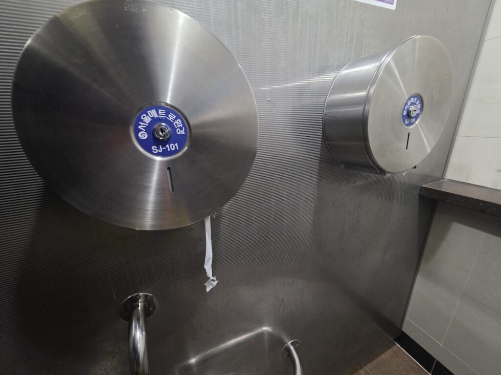"A toilet stall inside a Korean subway restroom with toilet paper provided, showing that tissues are always available and no need to bring your own."