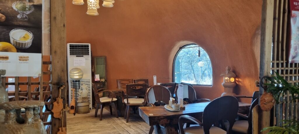 korean-traditional-teahouse-seoul “Interior of a Korean traditional teahouse with wooden tables and hanok architecture”
