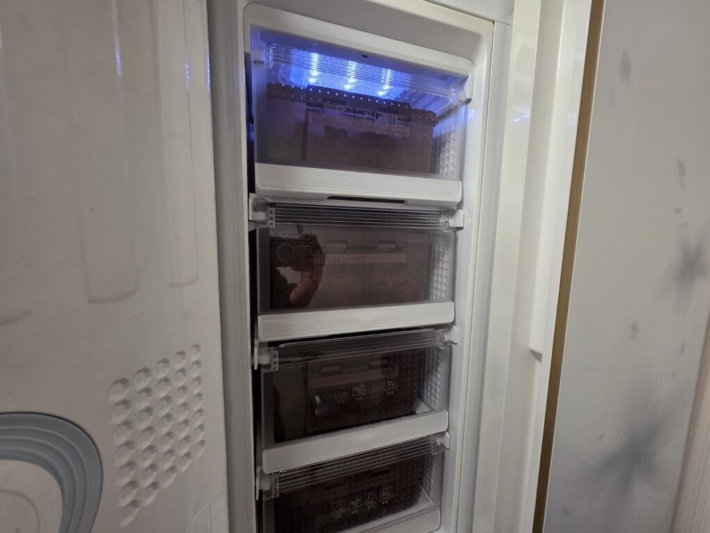 modern-stand-type-kimchi-fridge-interior The interior of a stand-type kimchi refrigerator with blue LED lighting and specialized compartments for fresh food preservation.