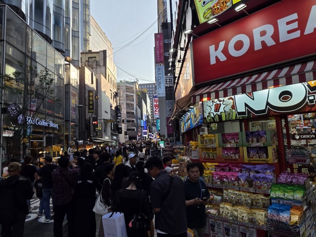 most-crowded-places-seoul-weekends-myeongdong-alley-tourists Packed Myeongdong alley on weekend with international tourists and shoppers showing why it ranks among most crowded places in Seoul on weekends