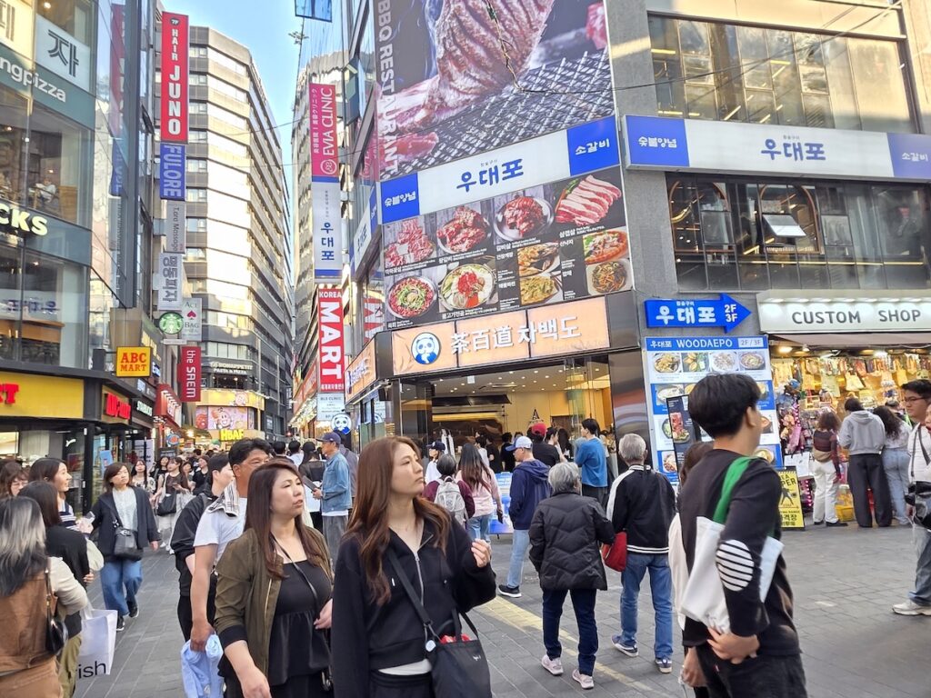 Crowded Myeongdong street on weekend showing one of the most crowded places in Seoul with tourists and shoppers filling the narrow pedestrian zone
