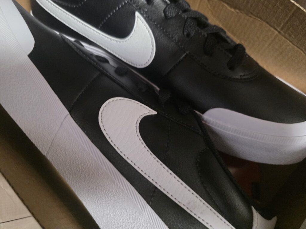 nike-shoes-gift-for-father-paju-outlet A pair of black and white Nike sneakers purchased as a gift for a 70-year-old father, showcasing the successful "Double Discount" ritual at Shinsegae Simon Premium Outlets Paju.