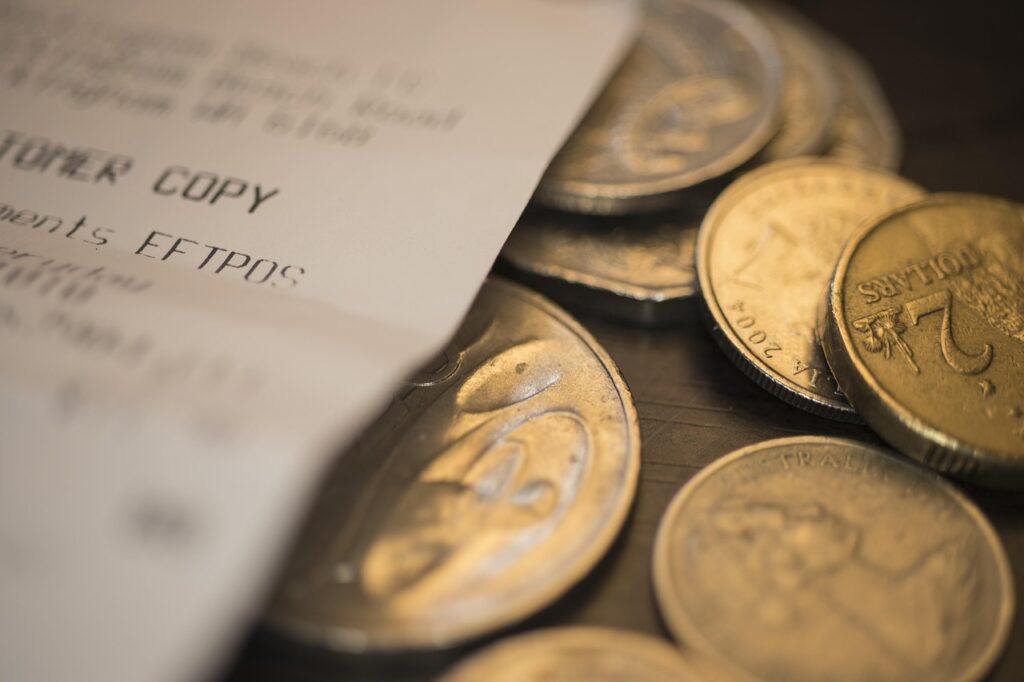 "A pile of Korean won coins on a table, representing money, cost of living, and personal budgeting in Korea 2025."