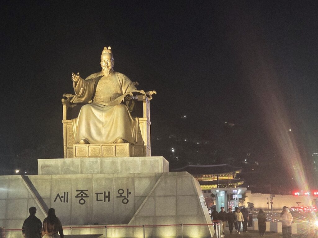 sejong-king-visa-korea-integration The King Sejong statue at night in Gwanghwamun, symbolizing the language proficiency and cultural adaptation integral to the D-8 visa Korea requirements framework.