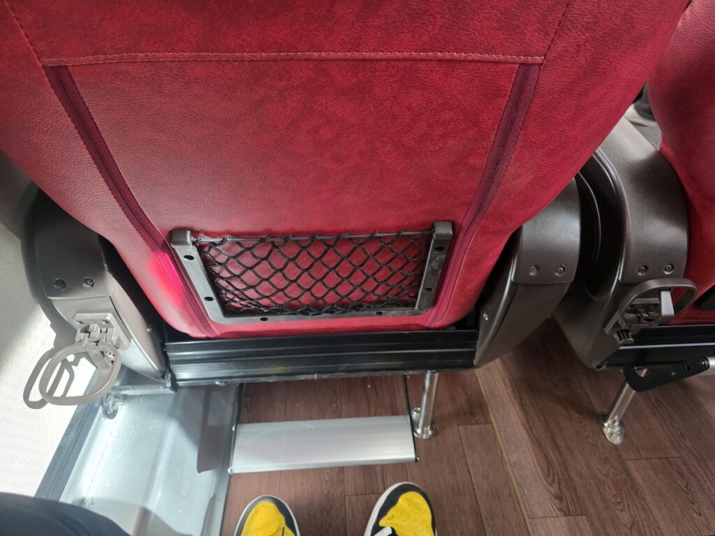 seoul-express-bus-terminal-guide-bus-legroom Spacious legroom and a footrest on a Korean bus, showcasing the comfort level in our Seoul Express Bus Terminal Guide.