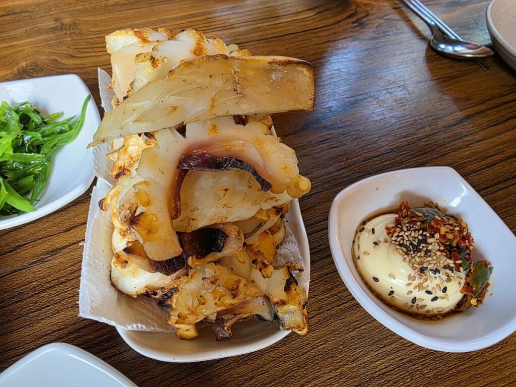 “Grilled Korean dried squid served with dipping sauce, a popular beer snack in Seoul markets”