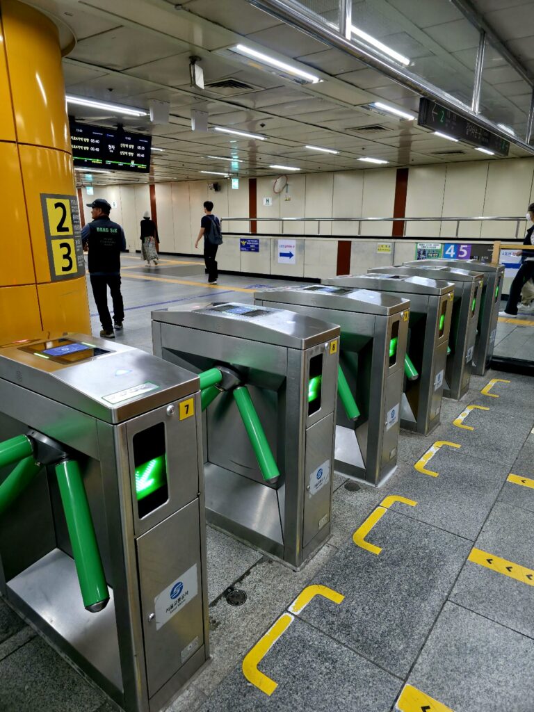 Close-up of a Line 2 ticket gate showing the card reader and entry indicators.