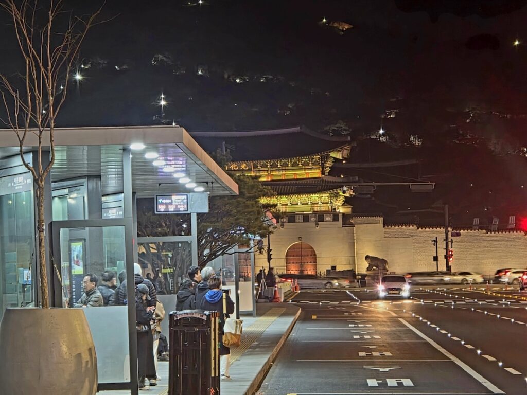 A sophisticated night view of Gwanghwamun Gate, the heart of Seoul, symbolizing the successful D-7 to F-2-7 visa Korea transition for global professionals.