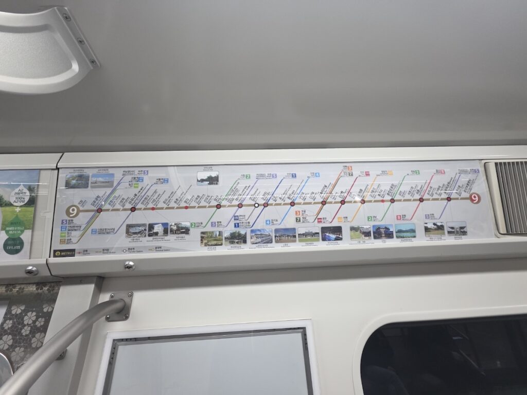 seoul-subway-line-9-route-map-2026 Complete route map of Seoul Subway Line 9 inside a train, showing stops from Gimpo Airport to VHS Medical Center.