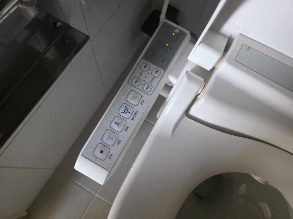 smart-bidet-control-panel-settings Close-up of a Korean bidet control panel showing various functions like wash, bidet, dry, and seat temperature.