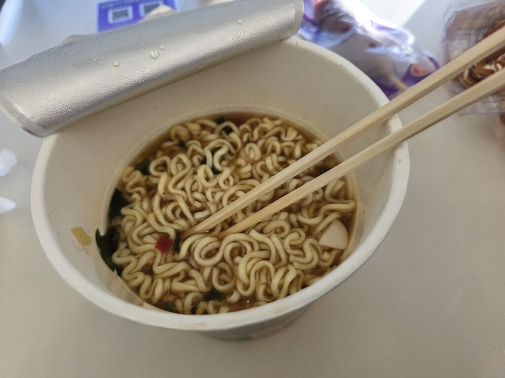south-korea-convenience-stores-instant-ramen A close-up of prepared cup ramen and chopsticks inside one of the many South Korea convenience stores showing a quick meal.