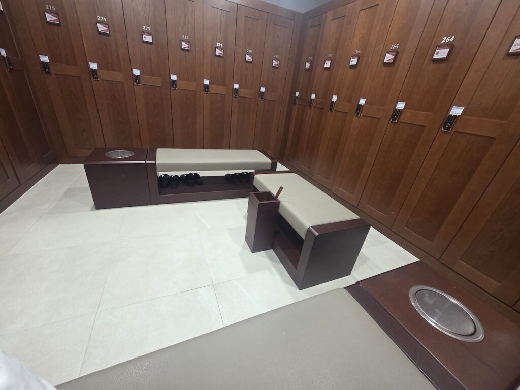 south-korea-golf-prices-luxury-locker-room A high-end wooden locker room inside a Korean golf clubhouse featuring premium benches and secure storage.