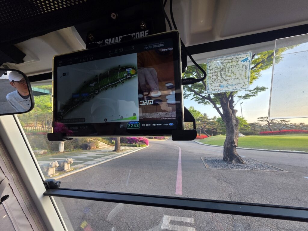 A Smartscore GPS tablet mounted inside a golf cart showing the course map and current hole layout in South Korea.