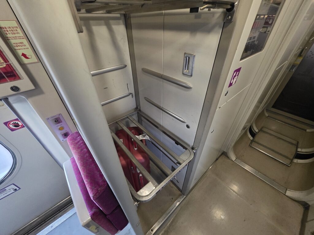 srt-luggage-storage-rack-cabin-interior The dedicated luggage storage area inside an SRT carriage, essential for travelers with heavy suitcases.