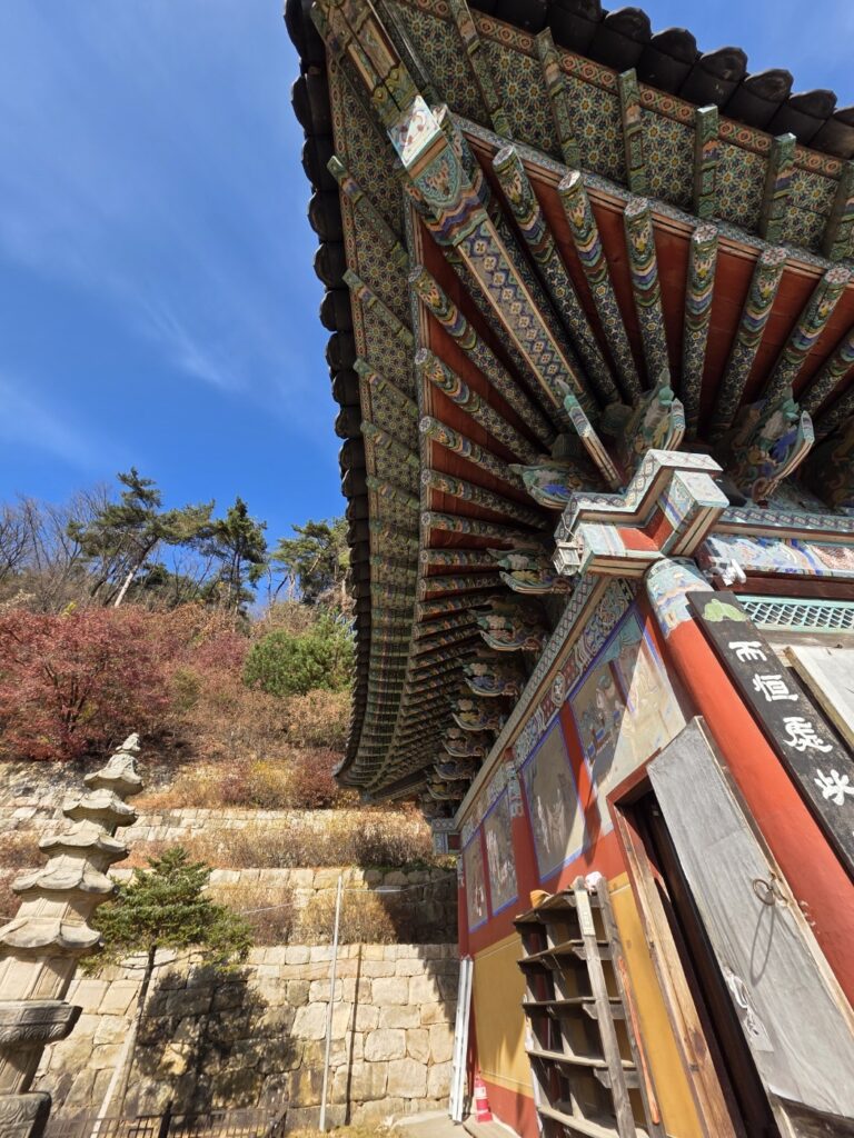 A quiet, peaceful courtyard scene within the Sujongsa Temple complex, emphasizing the Zen atmosphere.