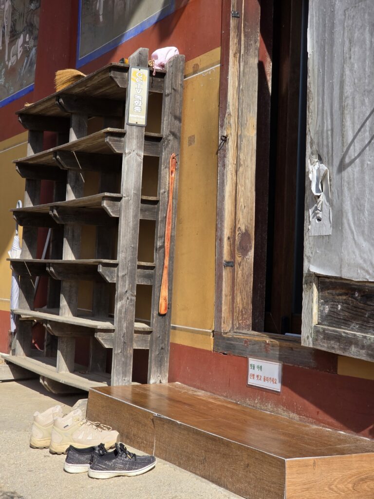 Shoes neatly placed outside the entrance of a main hall at Sujongsa Temple, illustrating the Korean temple etiquette.