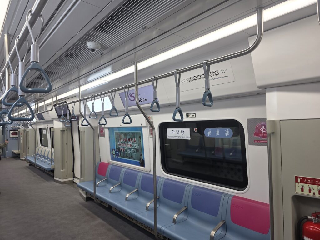 top-family-friendly-destinations-seoul-subway-seats Inside a modern GTX-A subway train in Seoul, highlighting why Korea features top family-friendly destinations with specialized priority seats and stroller space.