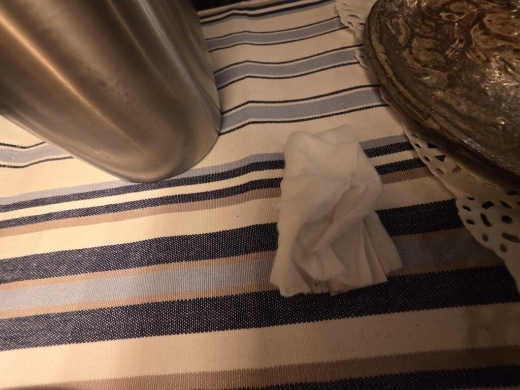 unwrapped-moist-wet-wipe-for-dining An unwrapped, thick moist wet wipe ready to be used before a meal in a Korean restaurant.