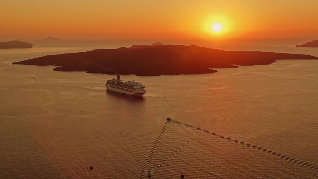 usa-to-south-korea-cruise-travel-guide-2026-aerial-sunset An aerial shot of a luxury liner crossing the ocean at sunset, illustrating the USA to South Korea Cruise Travel Guide 2026 narrative.