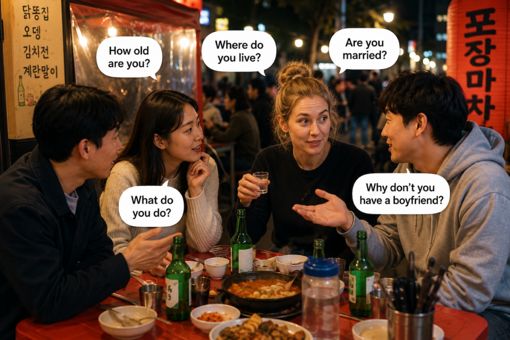 why-koreans-ask-personal-questions-so-early-korea A foreign woman talking with Korean friends at a Korean street food restaurant while being asked personal questions, showing why Koreans ask personal questions so early