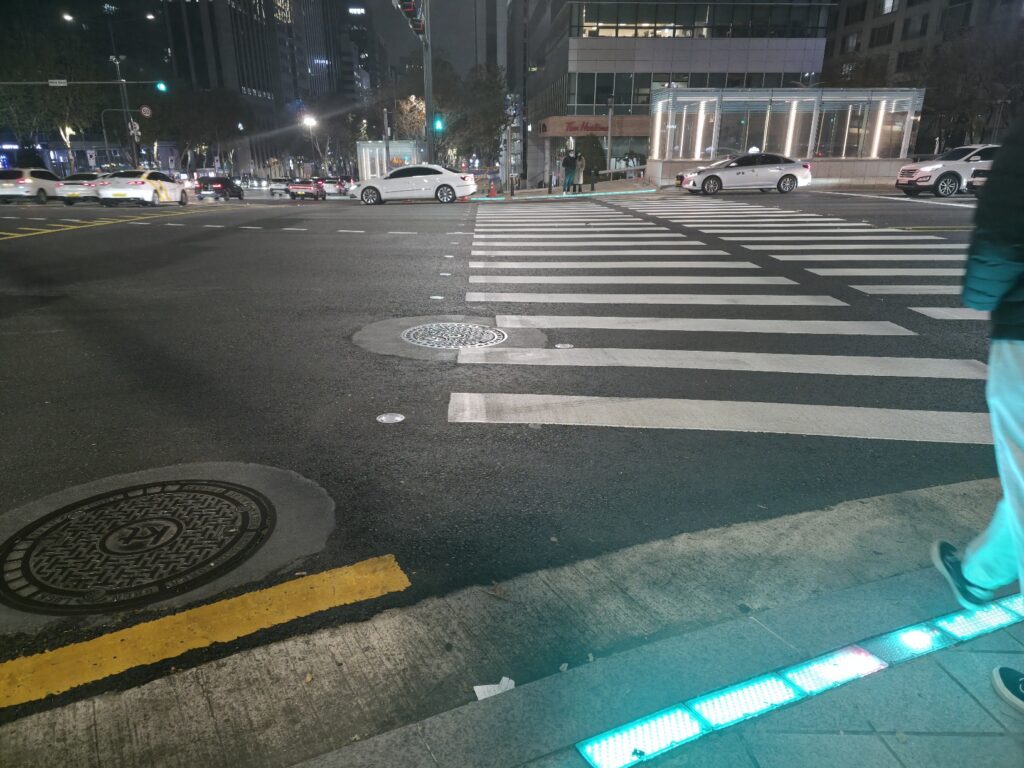 An urban view near Yeoksam Station, featuring buildings, traffic, and typical Gangnam scenery.